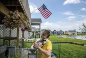  ?? CORY MORSE—THE GRAND RAPIDS PRESS VIA AP ?? In this Thursday, Aug. 2, 2018photo, Dylan Dyke, a 12-year-old Michigan boy with autism, spends time with one of his ducks, Nibbles, outside his Georgetown Township, Mich. home. New guidelines will allow Dyke to keep his ducks, which are his emotional support animals. Georgetown Township officials had issued a nuisance order to Mark and Jennifer Dyke after receiving multiple complaints from neighbors about their son Dylan’s ducks straying from their property. An ordinance variance approved Wednesday night, Sept. 26 includes guidelines, including specifics on the ducks’ coop.