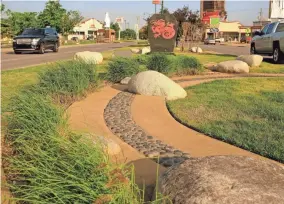  ??  ?? A sculpted garden with dragon-engraved granite is in the median of Classen Boulevard in the Asian District.