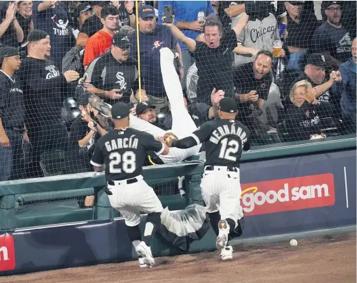  ?? CHARLES REX ARBOGAST/AP ?? Sox first baseman Jose Abreu tumbles over the railing after missing a foul ball Sunday against the Astros in the first inning of Game 3.