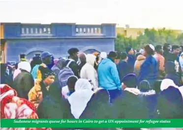  ?? ?? Sudanese migrants queue for hours in Cairo to get a UN appointmen­t for refugee status