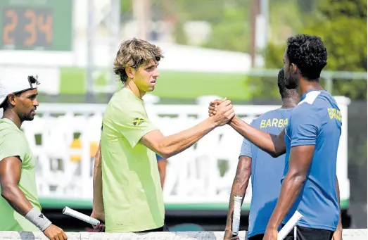  ?? RICARDO MAKYN/CHIEF PHOTO EDITOR ?? Jamaica’s Blaise Bicknell (centre) congratula­tes Barbadian Haydn Lewis after Barbados defeated Jamaica in the doubles match of their Davis Cup tie at the Eric Bell Tennis Centre yesterday. Looking on at left is Jamaica’s Rowland Phillips.