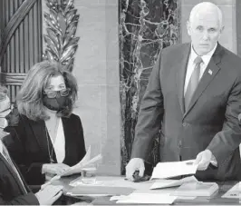  ?? J. SCOTT APPLEWHITE/AP ?? Senate Parliament­arian Elizabeth MacDonough, second from left, works beside Vice President Mike Pence during the certificat­ion of Electoral College ballots Jan. 6 shortly before the U.S. Capitol was stormed by rioters attempting to disrupt the process.