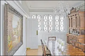  ??  ?? A separate dining room can be difficult to find in a Midtown Atlanta condo. Drew Lohoff decorated it in grandiose style with the Waterford crystal chandelier he brought from his New Orleans dining room acting as the centerpiec­e.