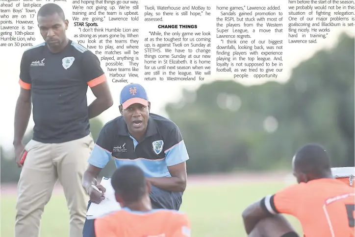  ?? GLADSTONE TAYLOR ?? Sandals South Coast FC head coach Aaron Lawrence is deep in discussion with his squad, who were trailing Cavalier SC 2-0 at half time in their Red Stripe Premier League clash at the Stadium East field on February 7. Sandals lost the game 2-1.