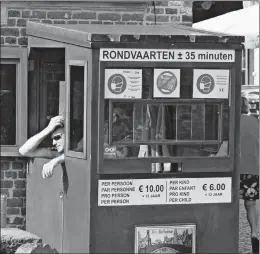  ?? VIRGINIA MAYO/AP PHOTOS ?? A ticket vendor slumps in his booth Aug. 24 in Bruges, Belgium. The pandemic has ravaged tourism across Europe this year and hopes for a resurgence in autumn are dim.