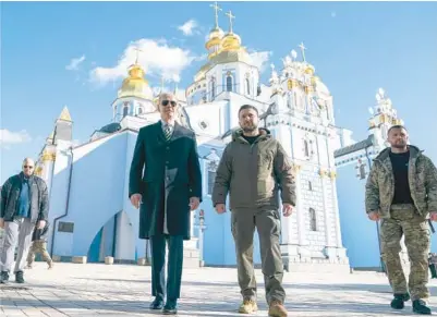  ?? EVAN VUCCI/AP ?? President Joe Biden walks with Ukrainian President Volodymyr Zelenskyy at St. Michael’s Golden-Domed Cathedral on a surprise visit Monday in Kyiv. Biden spent more than five hours in the Ukrainian capital, consulting with Zelenskyy on next steps, honoring the country’s fallen soldiers and seeing U.S. embassy staff in the besieged country.