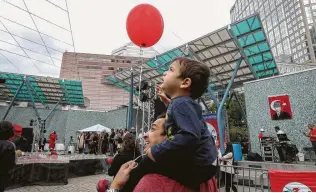  ?? Steve Gonzales / Staff photograph­er ?? Bata Ormnaci, 2, watches a dove and balloon release on the shoulders of his father, Oguz, during the annual Houston Turkish Festival on Saturday. The festival is set to reopen at 11 a.m. Sunday.