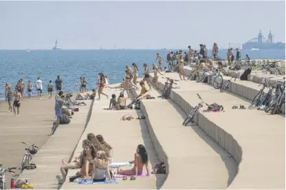  ?? ASHLEE REZIN GARCIA/SUN-TIMES ?? Chicago’s beaches are officially closed, but that didn’t keep people from jumping into Lake Michigan as temperatur­es stayed in the 90s the past week.