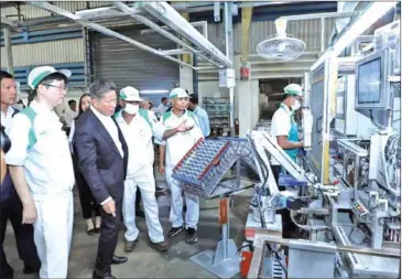  ?? CHANTHOL FB ?? CDC’s Sun Chanthol (in black suit) tours the Poipet Special Economic Zone (SEZ) on February 24.