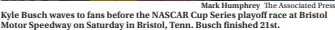  ?? Mark Humphrey The Associated Press ?? Kyle Busch waves to fans before the NASCAR Cup Series playoff race at Bristol Motor Speedway on Saturday in Bristol, Tenn. Busch finished 21st.