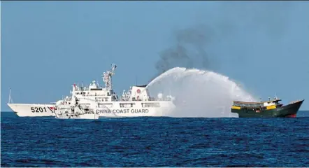  ?? reuters ?? Rising tension?: China Coast Guard vessels (left) firing a water cannon toward philippine resupply vessel Unaizah May 4 as it sails to Second Thomas Shoal in the South China Sea last month. —