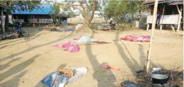  ?? Agence France-presse ?? Bodies of policemen killed in a militant attack are covered at the Yoetayoke police station in Rakhine State on Sunday.