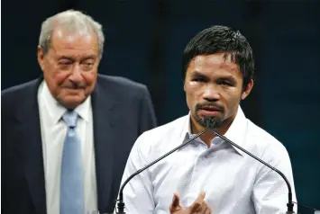  ?? ASSOCIATED PRESS ?? Promoter Bob Arum, left, watches Manny Pacquiao during a news conference following Pacquiao’s welterweig­ht title fight vs. Floyd Mayweather.