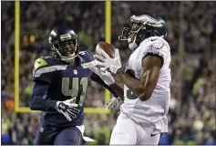  ?? TED S. WARREN — THE ASSOCIATED PRESS FILE ?? Nelson Agholor grabs a pass for a touchdown as the Seahawks’ Byron Maxwell trails in December 2017 in Seattle. Agholor on Saturday agreed to terms with the Raiders.