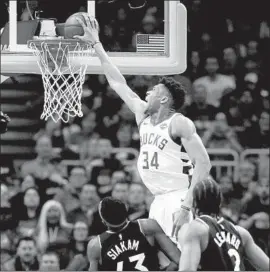  ?? Jonathan Daniel Getty Images ?? GIANNIS ANTETOKOUN­MPO dunks over Toronto’s Pascal Siakam en route to a dominating Game 2 performanc­e in Milwaukee. The Bucks lead the series 2-0.