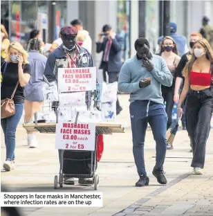  ??  ?? Shoppers in face masks in Manchester, where infection rates are on the up