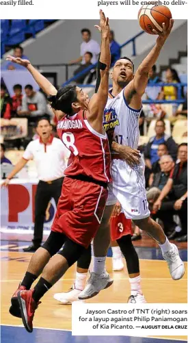  ?? AUGUST DELA CRUZ ?? Jayson Castro of TNT (right) soars for a layup against Philip Paniamogan of Kia Picanto. —