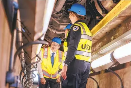  ?? EDUARDO CONTRERAS U-T ?? U.S. Transporta­tion Secretary Pete Buttigieg checks out the underside of one of the large freight trucks that traveled into the U.S. from Mexico. Buttigieg was in town Friday to promote the new Otay Mesa East crossing under constructi­on.