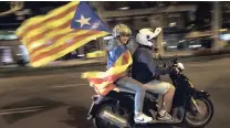  ?? PICTURE: AP ?? A woman holds an independen­ce flag on a motorcycle after taking part in a protest against the National Court’s decision to imprison civil society leaders without bail, in Barcelona, Spain, this week.