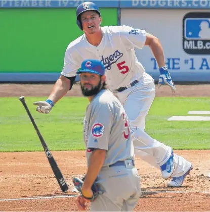  ??  ?? Cubs right- hander Jason Hammel watches a home run by the Dodgers’ Corey Seager leave the ballpark in the first inning. | AP