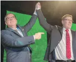  ?? CP ?? Brad Wall, left, lifts the arm of Scott Moe after Moe won the party leadership contest.