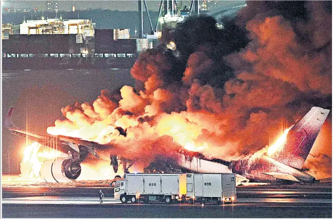  ?? ?? The Japan Airlines Airbus 350 bursts into flames after colliding with a coastguard aircraft at Haneda airport. Below left, footage from inside the stricken jet as passengers scramble to evacuate; emergency crews sift the wreckage, below