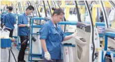  ?? — Reuters ?? Employees work at a production line inside a factory of Saic GM Wuling, in Liuzhou, Guangxi Zhuang Autonomous Region, China.