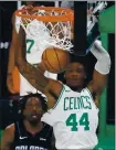  ?? MICHAEL DWYER — AP ?? The Celtics’ Robert Williams III (44) dunks in front of the Magic’s Al-Farouq Aminu on Sunday.