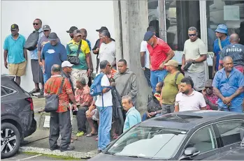  ?? Picture: JONACANI LALAKOBAU ?? Bystanders and supporters await the verdict of former prime minister Voreqe Bainimaram­a and suspended Commission­er of Police Sitiveni Qiliho’s case outside the Magistrate Court in Suva on Thursday.