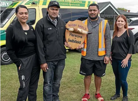  ?? BEJON HASWELL/STUFF ?? The recently found shield that rugby teams from South Canterbury’s two meatworks will once again play for. From left are Jaimee Wiki and Teki Veikune, representi­ng Silver Fern Farms Pareora, and Siu Kakaia and Emma O’Connell, representi­ng Alliance Smithfield.