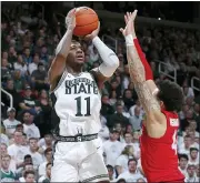  ?? ASSOCIATED PRESS FILE PHOTO ?? Michigan State’s Aaron Henry, left, shoots against Ohio State’s Duane Washington Jr. during the second half of a March 8 game in East Lansing.