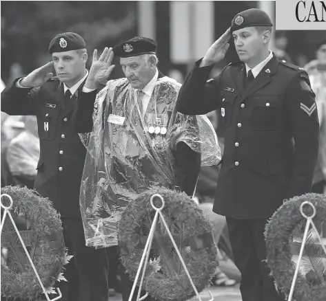  ?? JUSTIN TANG / THE CANADIAN PRESS ?? Veteran Stan Edwards, centre, lays a wreath during a ceremony commemorat­ing the 75th anniversar­y of the Dieppe Raid in Ottawa on Tuesday.