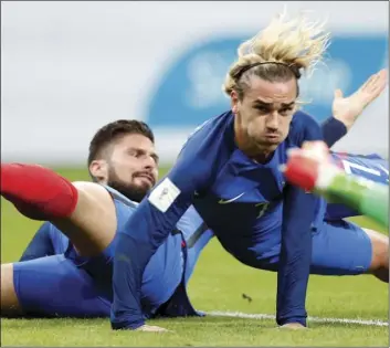  ?? PHOTO/CHRISTOPHE ENA ?? France’s Olivier Giroud (left) and France’s Antoine Griezmann fall during the World Cup Group A qualifying soccer match between France and Belarus at the Stade de France stadium in Saint-Denis, outside Paris, on Tuesday. AP