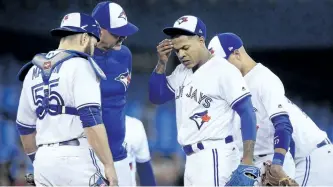  ?? NATHAN DENETTE/THE CANADIAN PRESS ?? Toronto Blue Jays starting pitcher Marcus Stroman, right, talks on the mound with catcher Russell Martin and pitching coach Pete Walker during fourth inning AL baseball action against the Baltimore Orioles in Toronto on Wednesday.