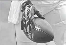  ?? Photograph­s by Allen J. Schaben Los Angeles Times ?? THERE HAS BEEN discussion of whether the NFL should come up with new regulation­s for the use of gloves. Some players use several pairs in each game.