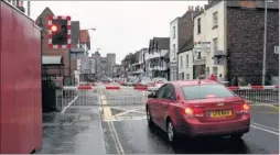  ??  ?? Traffic waits at the level crossing in St Dunstan’s