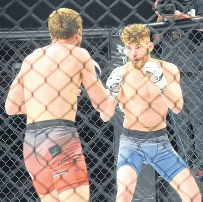  ?? FRAM DINSHAW PHOTOS/TRURO NEWS ?? Alberta's Jesse "Big Cat" Arnett, right, faced off against his Antigonish opponent Adam Macdougall at Fight League Atlantic's main event in Truro Feb. 8. Arnett went on to win the fight by submission in the third round after executing a rear naked chokehold.