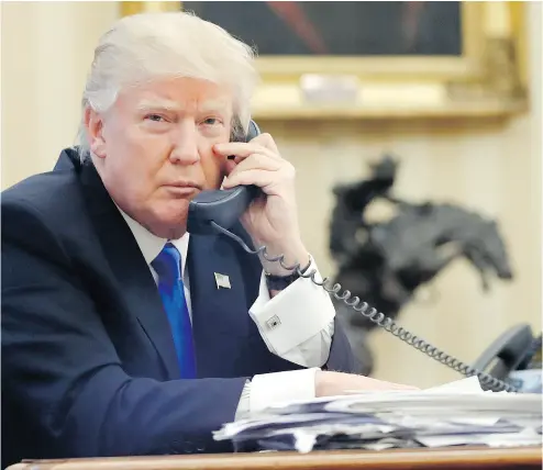  ?? ALEX BRANDON / THE ASSOCIATED PRESS ?? U. S. President Donald Trump speaks on the phone with Prime Minister of Australia Malcolm Turnbull in the Oval Office of the White House in Washington. Numerous reports suggest it was a phone call that was heated.