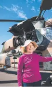  ??  ?? Army helicopter lover Pat Wilson with a ARH Tiger which regularly flies over her home of Lilyvale Meringanda­n West.