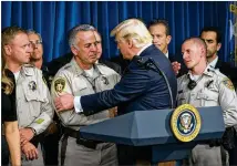  ?? DOUG MILLS/THE NEW YORK TIMES ?? President Donald Trump thanks Clark County Sheriff Joe Lombardo during a visit Wednesday to the Metropolit­an Police Department in Las Vegas. Trump praised first responders and also met with victims of Sunday’s shooting. Article, A6.