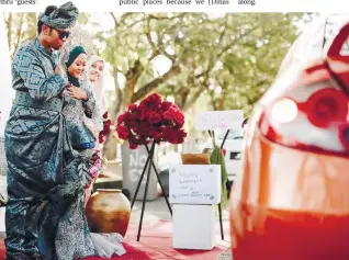  ??  ?? The couple greeting ‘guests’ during the event organisesd by Noorsaidat­ull. – PIX COURTESY OF MUHAMMAD FARID SAHAR