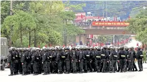  ?? AP ?? Vietnamese security stand outside the entrance to Dong Dang train station where North Korean leader Kim Jong Un is expected to arrive at the border town with China.