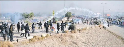  ??  ?? Pakistani riot police clash with protesters of the TLYRAP religious group during a protest in Islamabad. — AFP photo