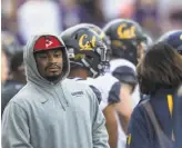  ?? Stephen Brashear / Getty Images 2015 ?? Marshawn Lynch, then with the Seahawks, stands on the Cal sideline during a game against Washington at Husky Stadium in Seattle in 2015.