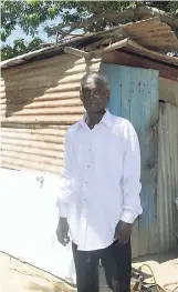  ??  ?? Malcolm Green, 76, stands in front of the zinc structure he once called home.