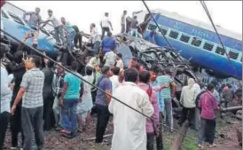  ??  ?? A bogie of the illfated Utkal Express rammed into a house, people rescuing the passengers trapped inside the derailed coaches and scene at the track where the train derailed on Saturday.