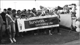  ?? FILE PHOTO ?? CANCER SURVIVORS AND CAREGIVERS FOR cancer patients walk the initial lap in last year’s Relay for Life in Yuma.