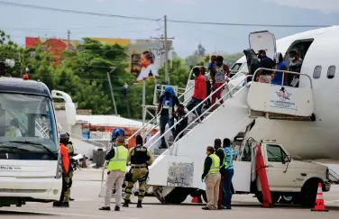  ?? ?? FILE - Haitians who were deported from the United States deplane at the Toussaint Louverture Internatio­nal Airport, in Port au Prince, Haiti, Sept. 19, 2021. More than 20,000 Haitians have been deported from the U.S. in 2022, as thousands more continue to flee Haiti. (AP Photo/Odelyn Joseph, File)