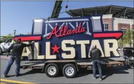  ?? JOHN SPINK — ATLANTA JOURNAL-CONSTITUTI­ON VIA THE ASSOCIATED PRESS ?? Workers load an All-Star sign onto a trailer after it was removed from Truist Park in Atlanta, on Tuesday.