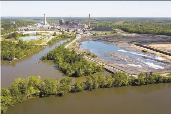  ?? Steve Helber / Associated Press 2018 ?? President Trump’s administra­tion has eased regulation of coal ash ponds, such as the ones at Dominion Energy’s Chesterfie­ld Power Station along the James River in Chester, Va.